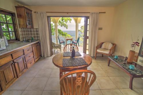 a kitchen with a table and chairs and a balcony at Catcha Falling Star in Negril