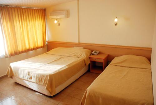 Postel nebo postele na pokoji v ubytování Grand Horizon Apart Hotel