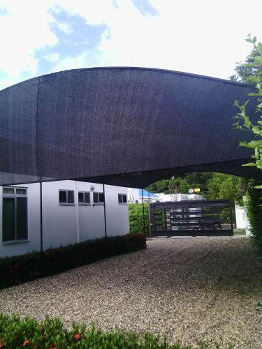 a building with a black roof and a garage at Casa 007 in Carmen de Apicalá