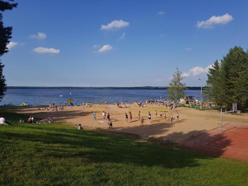 a group of people on a beach near the water at Domek Kruklanki in Kruklanki