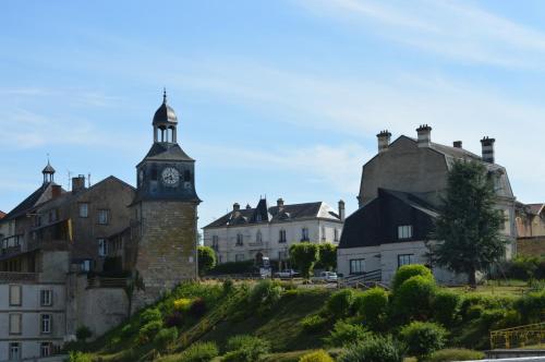 a group of buildings with a clock tower on a hill at Hotel du Grand Monarque in Varennes-en-Argonne