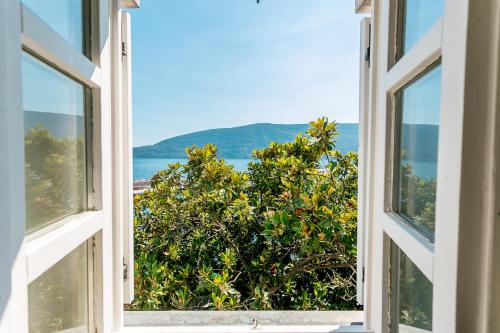 an open window with a view of the ocean at Stanica B&B in Herceg-Novi