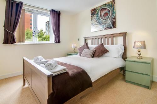 a bedroom with a large bed and a window at The Class Place in Birmingham