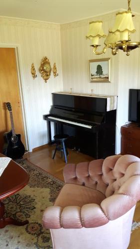 a living room with a couch and a piano at The Sheep Inn B&B in Arvika