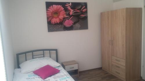 a bedroom with a bed and a picture on the wall at Hiša 2 in Tolmin