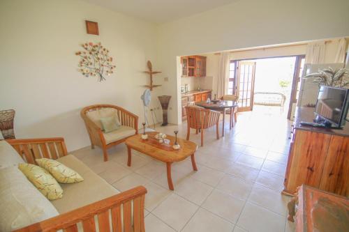 a living room with a couch and a table at Catcha Falling Star in Negril
