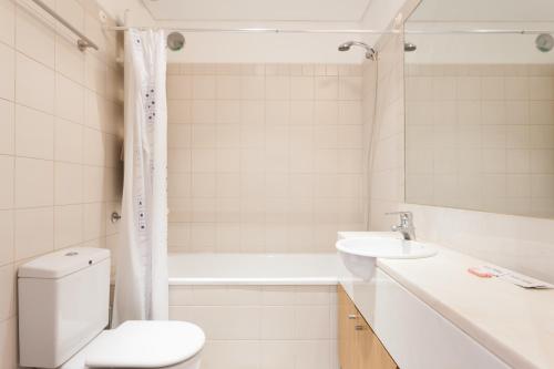 La salle de bains est pourvue de toilettes, d'un lavabo et d'une baignoire. dans l'établissement FLH Expo Flat with View, à Lisbonne
