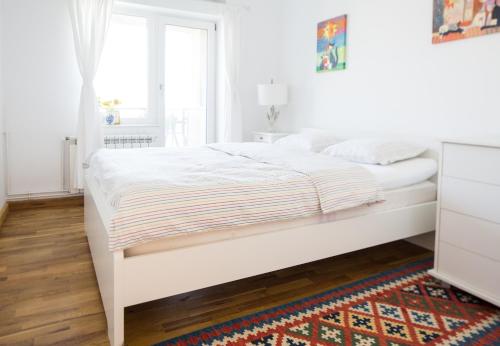 a white bed in a white bedroom with a window at Diana's Flat-the best-Bucharest - Old City in Bucharest