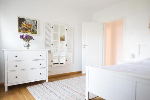 a white bedroom with a white dresser and a bed at Diana's Flat-the best-Bucharest - Old City in Bucharest