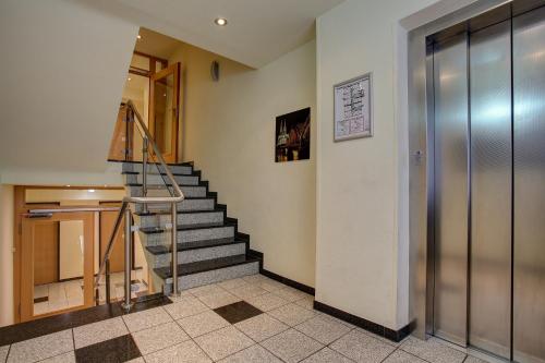 a lobby with a staircase in a building at Trip Inn Hotel Conti in Cologne
