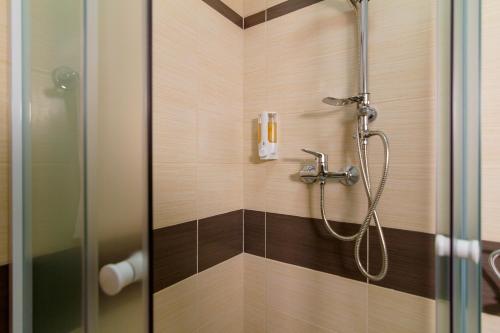 a shower in a bathroom with a glass door at Apartments Trend 2 in Rijeka