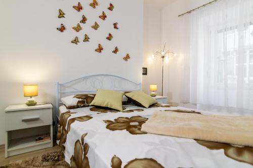 a bedroom with a bed with butterflies on the wall at Apartments Trend 2 in Rijeka