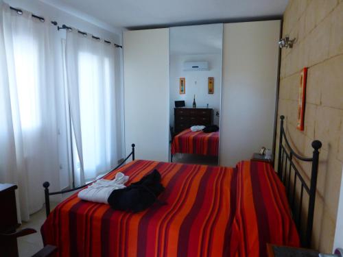 a bedroom with two beds and a mirror at Il prato sul terrazzo in Cagliari