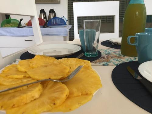 a plate of food with a fork on a table at B&B Villa Luna in Bayahibe