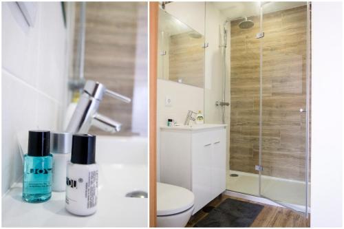 a bathroom with a toilet and a glass shower at Furabeach Alojamentos in Furadouro