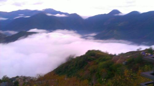a view of a mountain covered in clouds at Sunnydale B&B in Ren'ai
