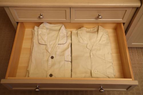 a wooden drawer with a white jacket in it at Hotel Monterey Kyoto in Kyoto