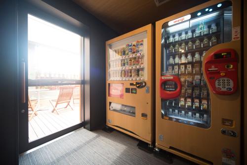 a vending machine filled with lots of bottles of beer at Dormy Inn Izumo in Izumo
