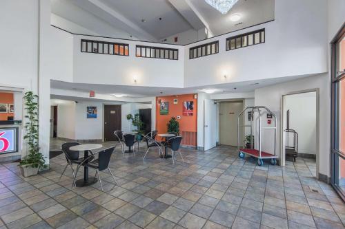 an empty room with chairs and tables in a building at Motel 6-Lawrence, KS in Lawrence