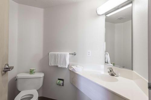 a bathroom with a sink and a toilet and a mirror at Motel 6-Cedar City, UT in Cedar City