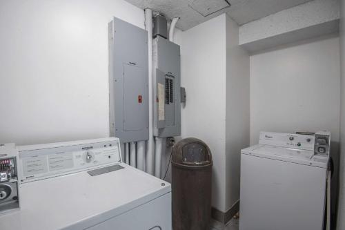 a laundry room with a refrigerator and a washer at Motel 6-Lawrence, KS in Lawrence