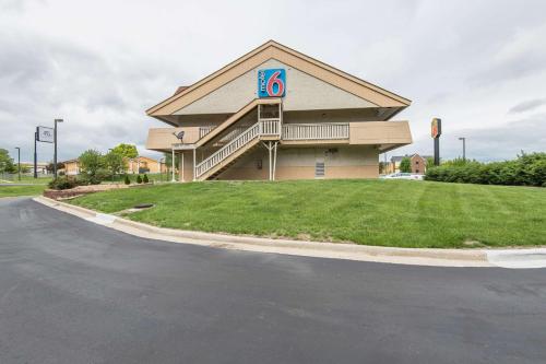 a building with a sign on the side of a road at Motel 6-Overland Park, KS in Overland Park