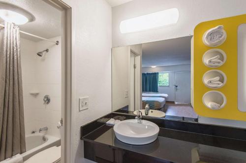 a bathroom with a sink and a mirror at Motel 6-Overland Park, KS in Overland Park