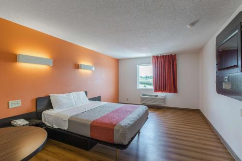 a hotel room with a bed and a window at Motel 6 Omaha - Central in La Vista