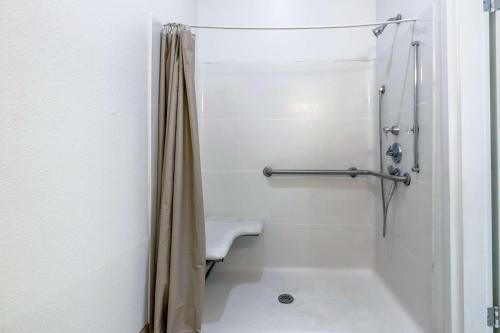 a bathroom with a shower with a sink and a toilet at Studio 6-Lafayette, LA - Broussard in Lafayette