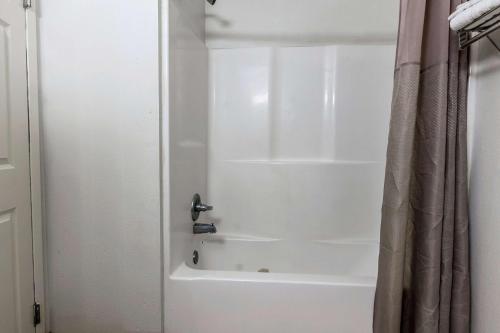 a bathroom with a shower with a white tub at Studio 6-Lafayette, LA - Broussard in Lafayette