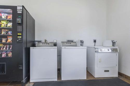 a kitchen with three refrigerators and a refrigerator at Studio 6-Lafayette, LA - Broussard in Lafayette