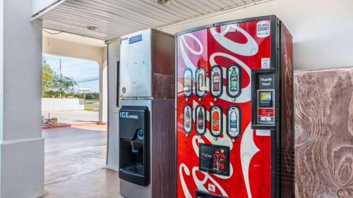 a red vending machine sitting next to a building at Motel 6-San Marcos, TX - North in San Marcos