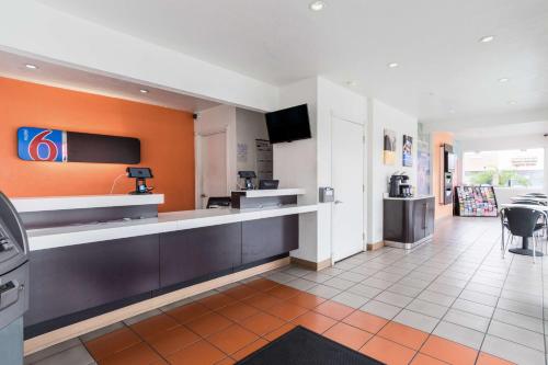 a large lobby with a bar in a hotel at Motel 6-Long Beach, CA - International City in Long Beach