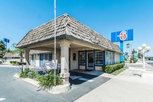 a gas station with a building on a street at Motel 6-Kingsburg, CA in Kingsburg
