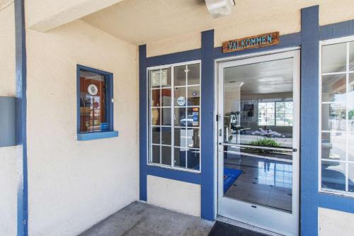 a door to a restaurant with a sign on it at Motel 6-Kingsburg, CA in Kingsburg
