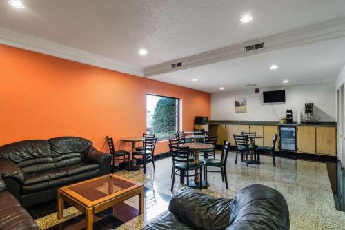 a living room with a couch and tables and chairs at Motel 6-Libertyville, IL in Libertyville