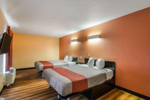 a motel room with two beds and a flat screen tv at Motel 6-Libertyville, IL in Libertyville