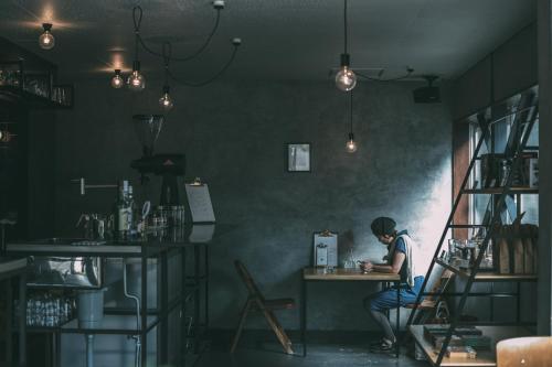 a person sitting at a table in a room at Nari Nuttari Nari in Niigata
