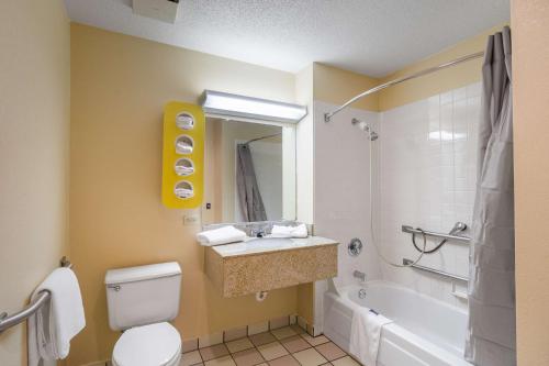 a bathroom with a toilet and a sink and a tub at Motel 6-Libertyville, IL in Libertyville