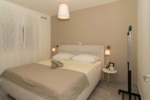 Postel nebo postele na pokoji v ubytování Apartmani Marinović