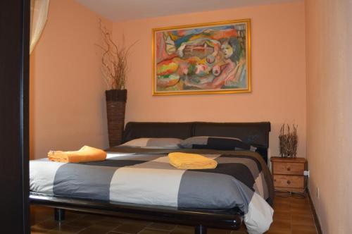 a bedroom with two beds and a painting on the wall at A pochi passi dal mare in Torre del Lago Puccini