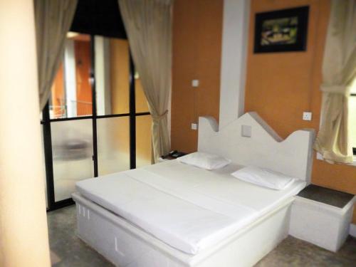 Ένα ή περισσότερα κρεβάτια σε δωμάτιο στο Ambalama Leisure Lounge