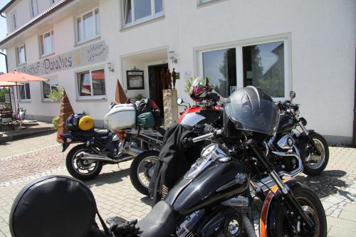 a group of motorcycles parked in front of a building at Adam & Eva Gasthof Paradies mit Hotel in Vogt