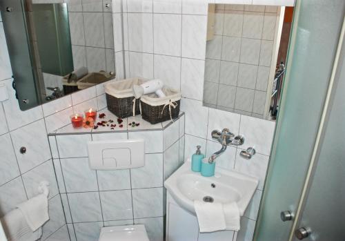 a bathroom with a sink and a toilet at Łeba Apartament in Łeba