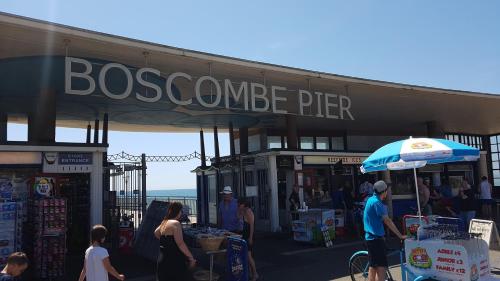 a group of people standing outside of a store at Boscombe Reef Hotel in Bournemouth