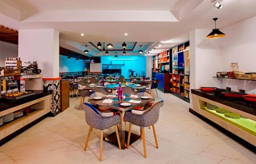 a restaurant with a table and chairs in a room at Zone By The Park, ORR, Chennai in Chennai