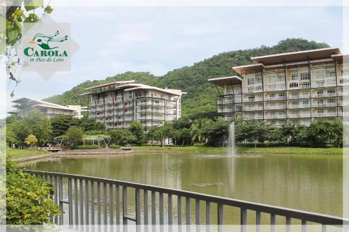 a building next to a lake with a fountain at CAROLA in Pico de Loro in Nasugbu