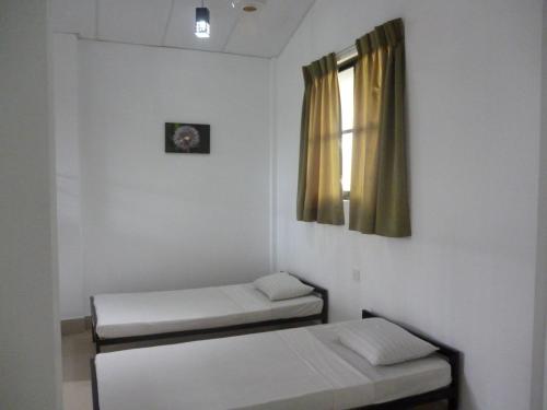 Ένα ή περισσότερα κρεβάτια σε δωμάτιο στο Ambalama Leisure Lounge