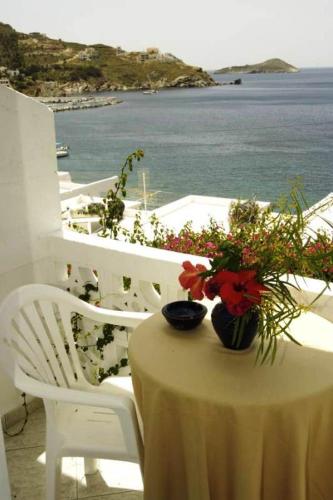 a table with flowers sitting on top of a balcony at Atlantis Hotel in Myrties