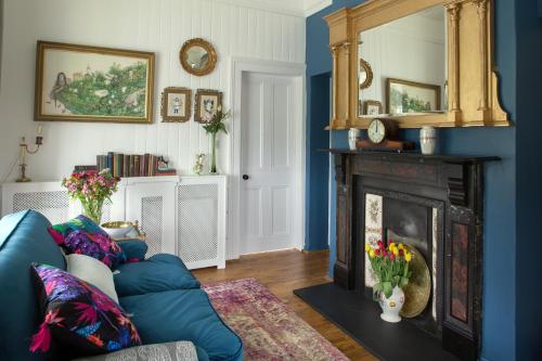 a living room with a couch and a fireplace at The Dolls House in Wexford